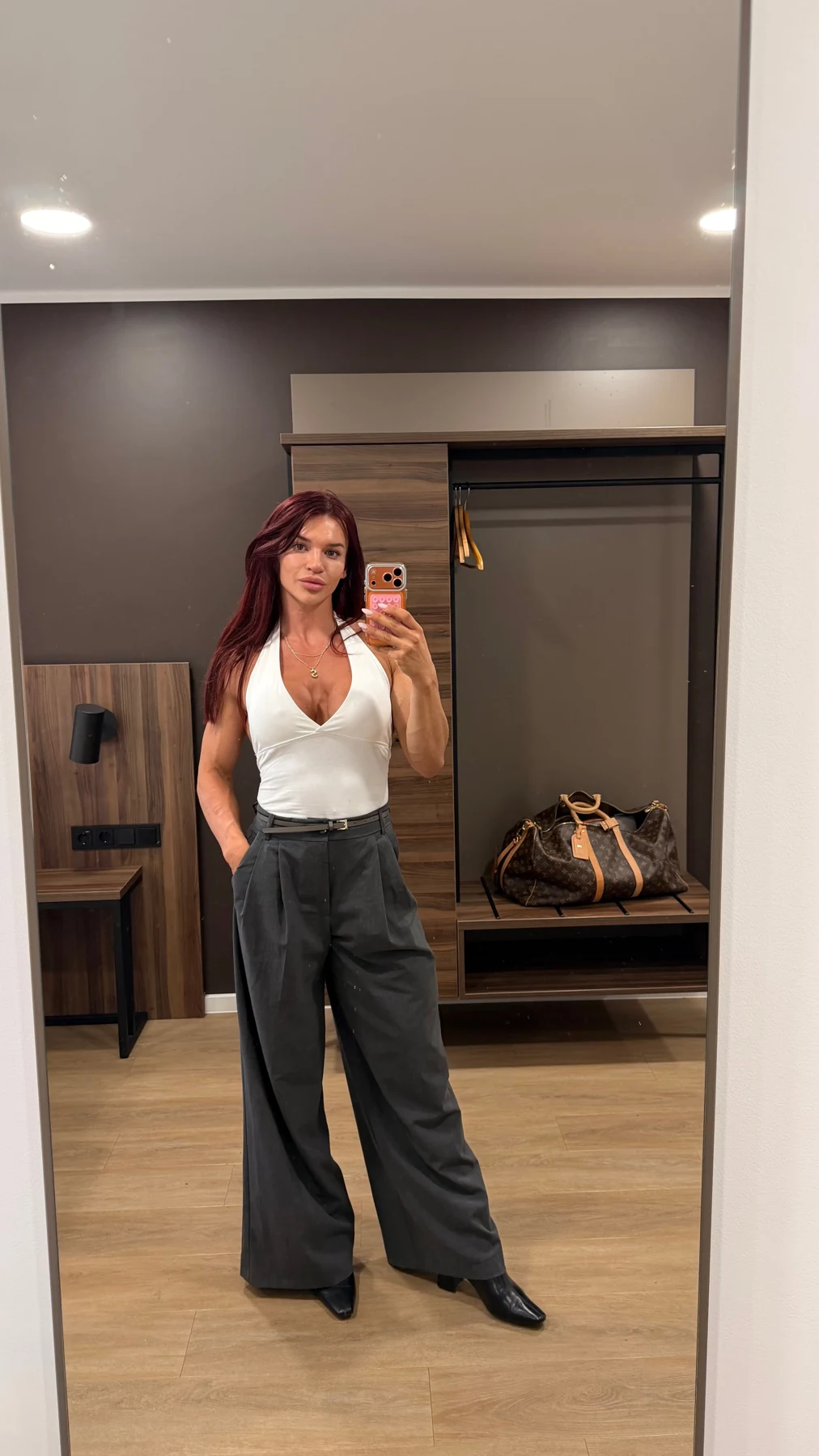 Sarah in a white top and dark trousers
